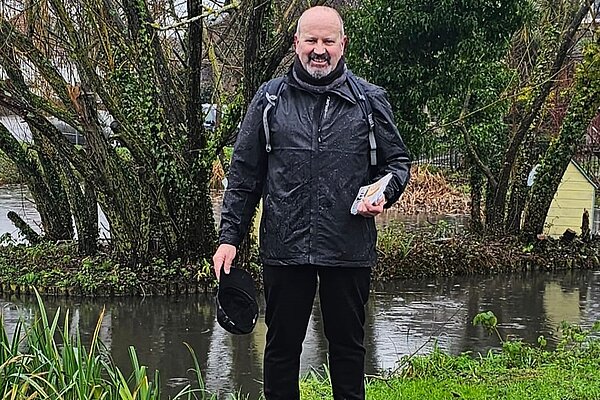 Lib Dem Cllr Frank O'Kelly delivering the Cippenham Focus in the rain